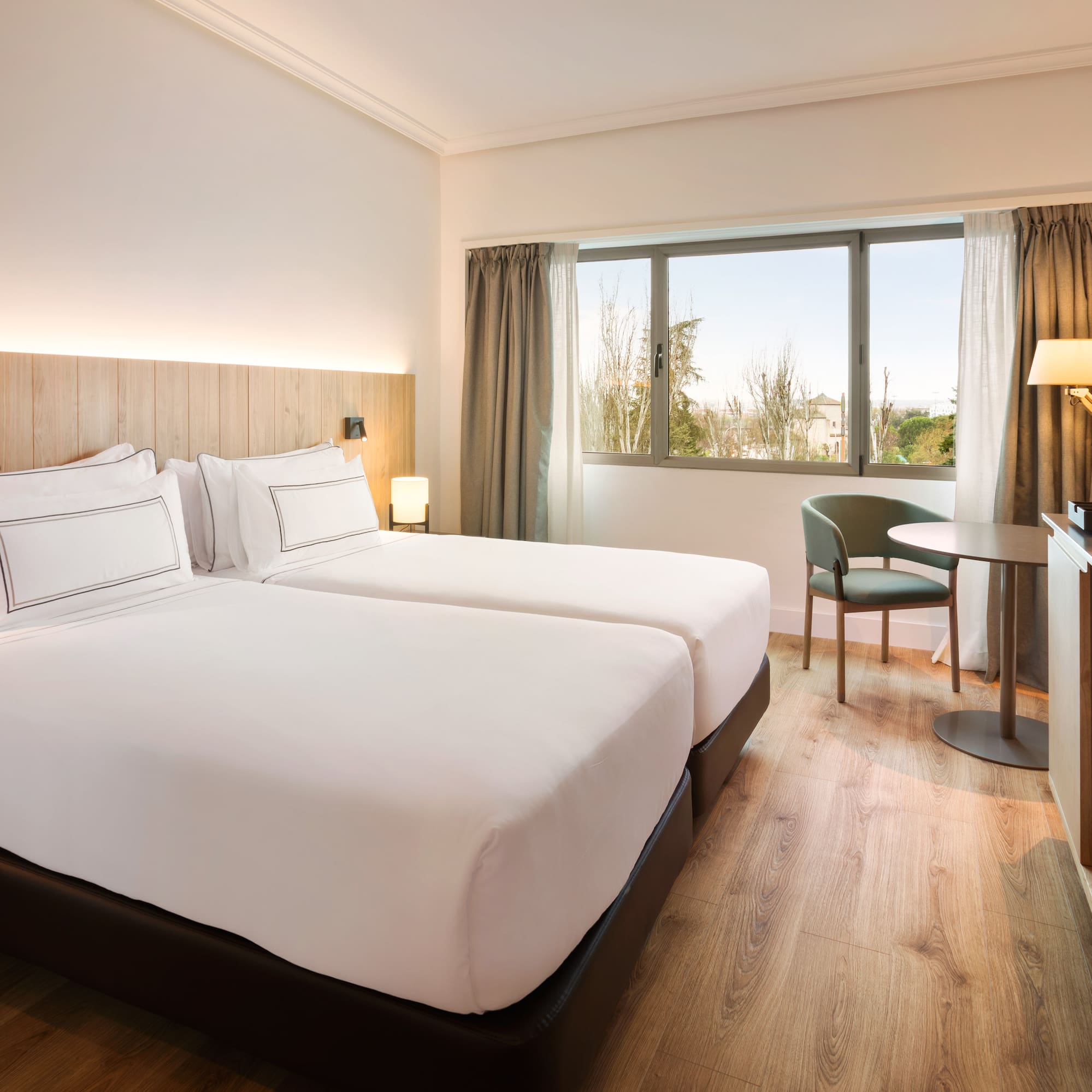 a room with two beds and a table