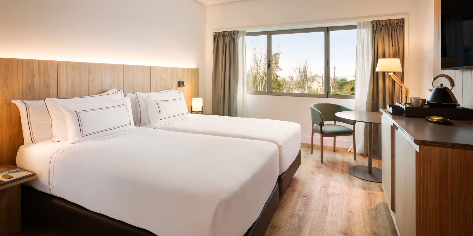 a room with two beds and a table