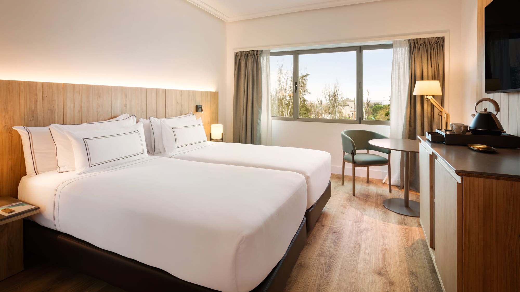 a room with two beds and a table