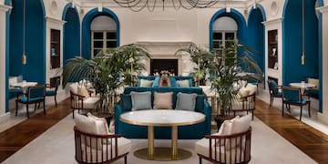 a room with a couch and chairs
