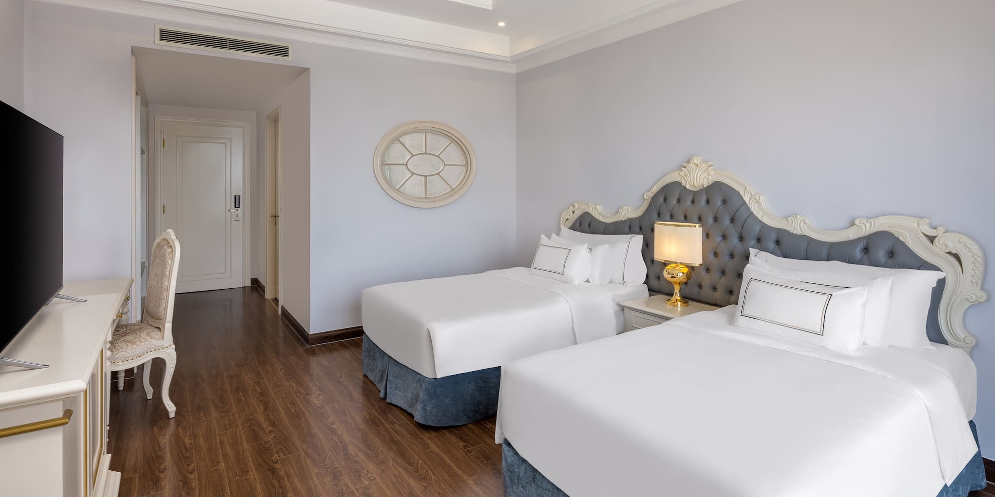 a room with two beds and a wood floor