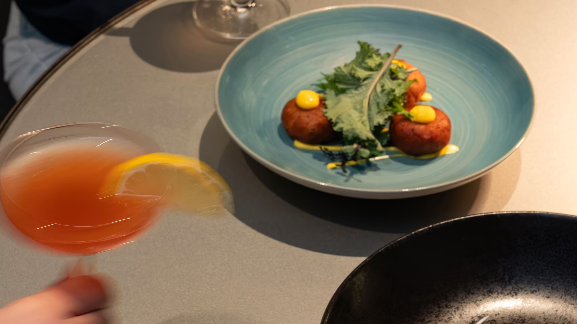 a person holding a glass of drink