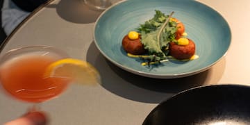 a person holding a glass of drink