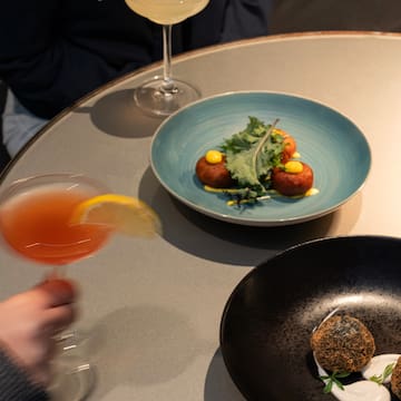 a person holding a glass of drink