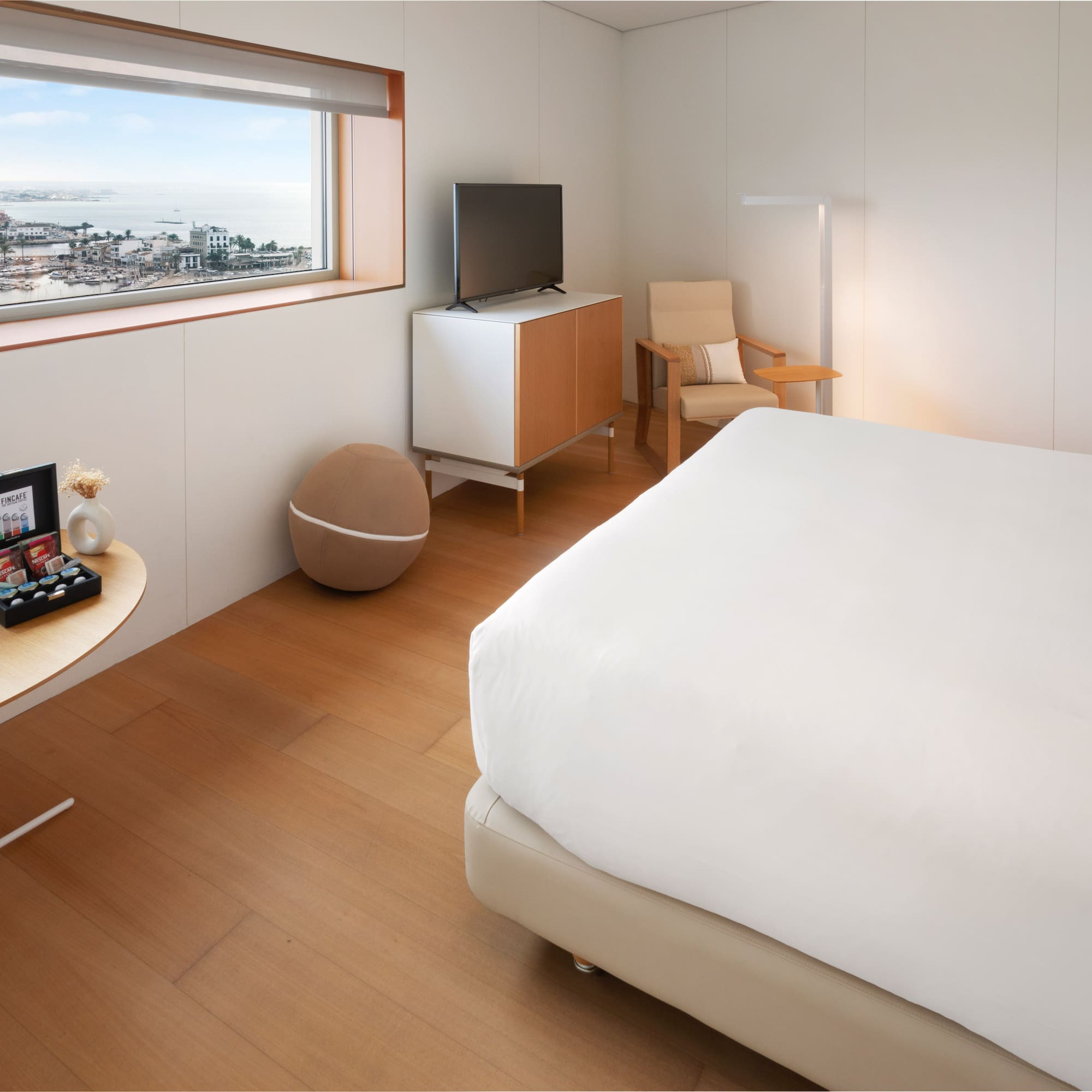 a bedroom with a bed and a television