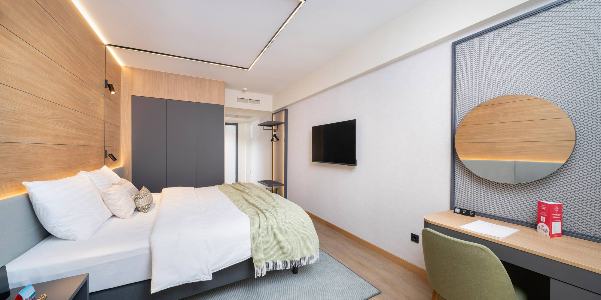 a bedroom with a bed and a tv