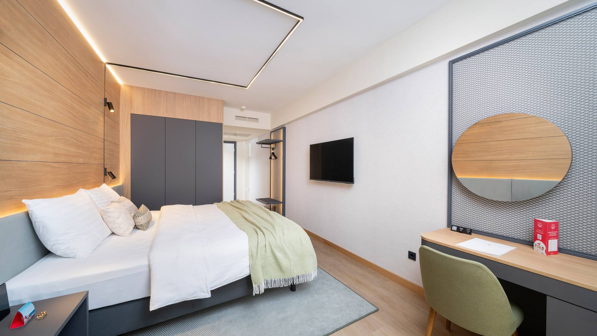 a bedroom with a bed and a tv