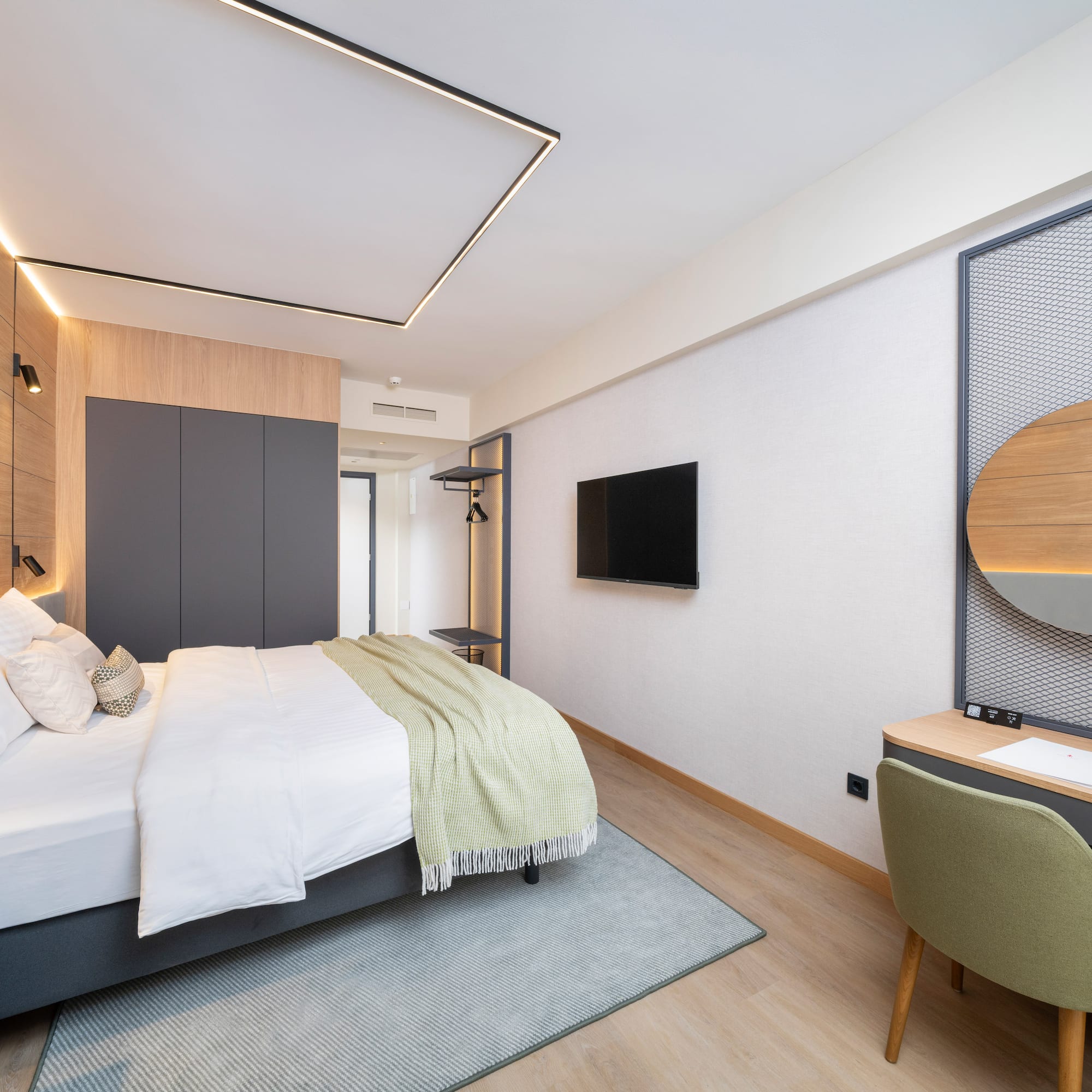 a bedroom with a bed and a tv