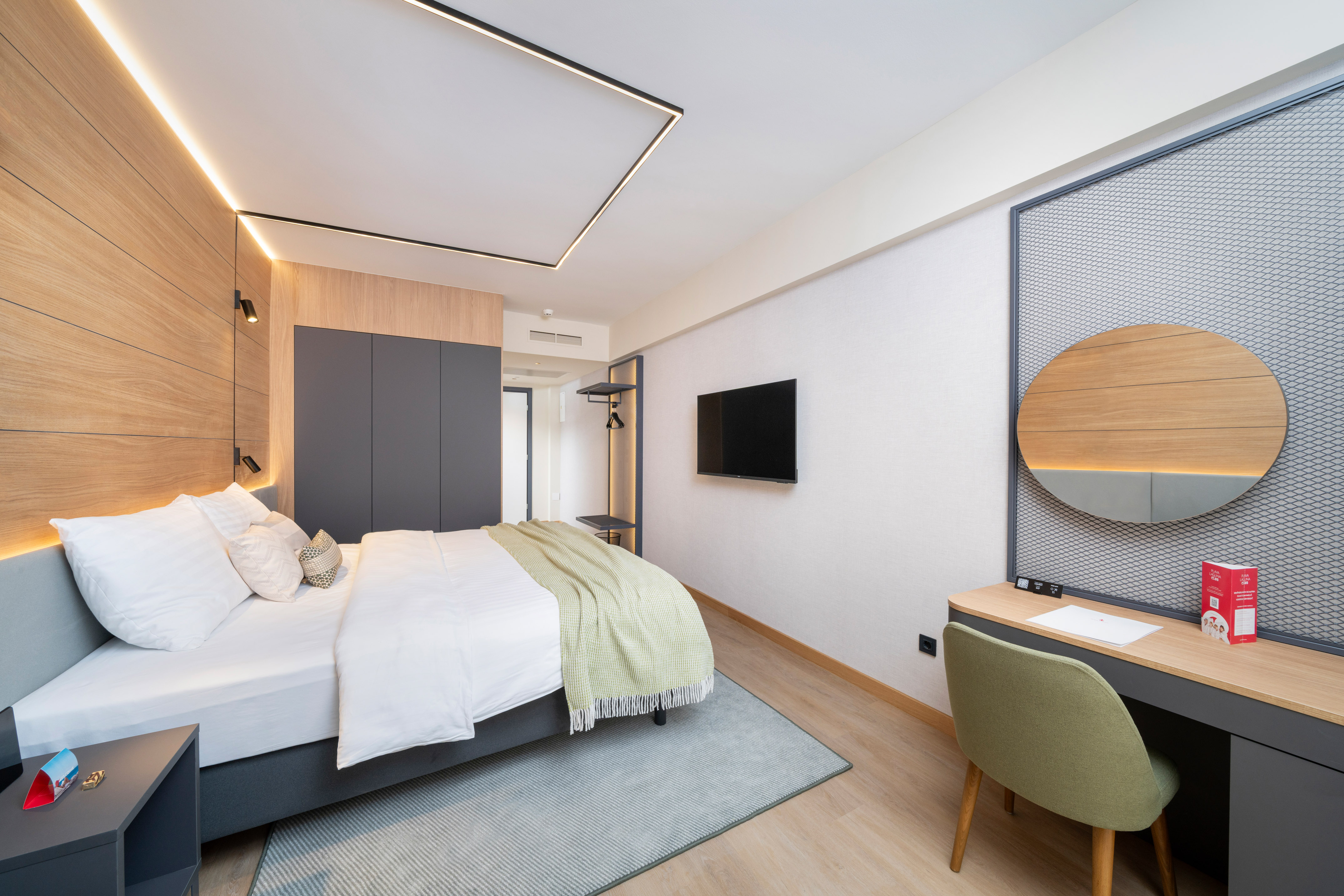 a bedroom with a bed and a tv