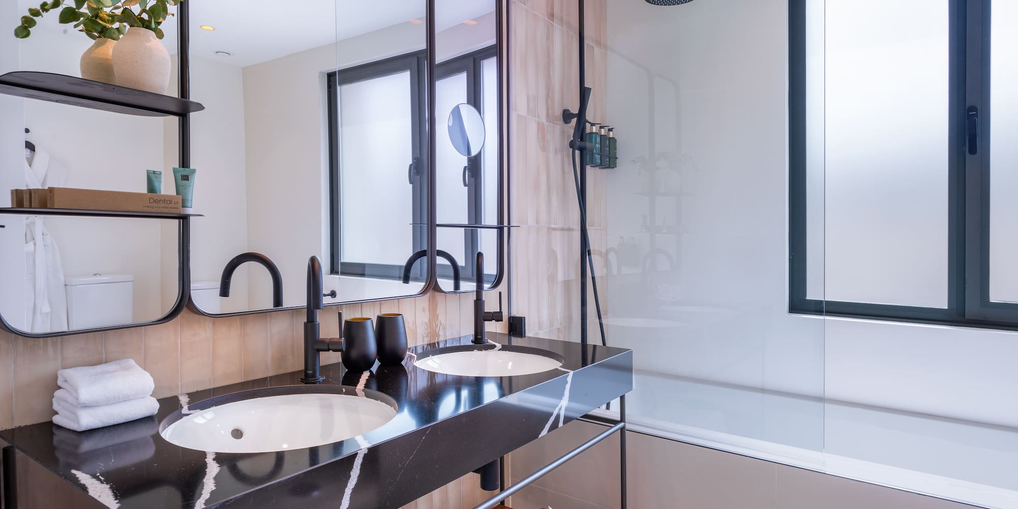a bathroom with a shower and two sinks