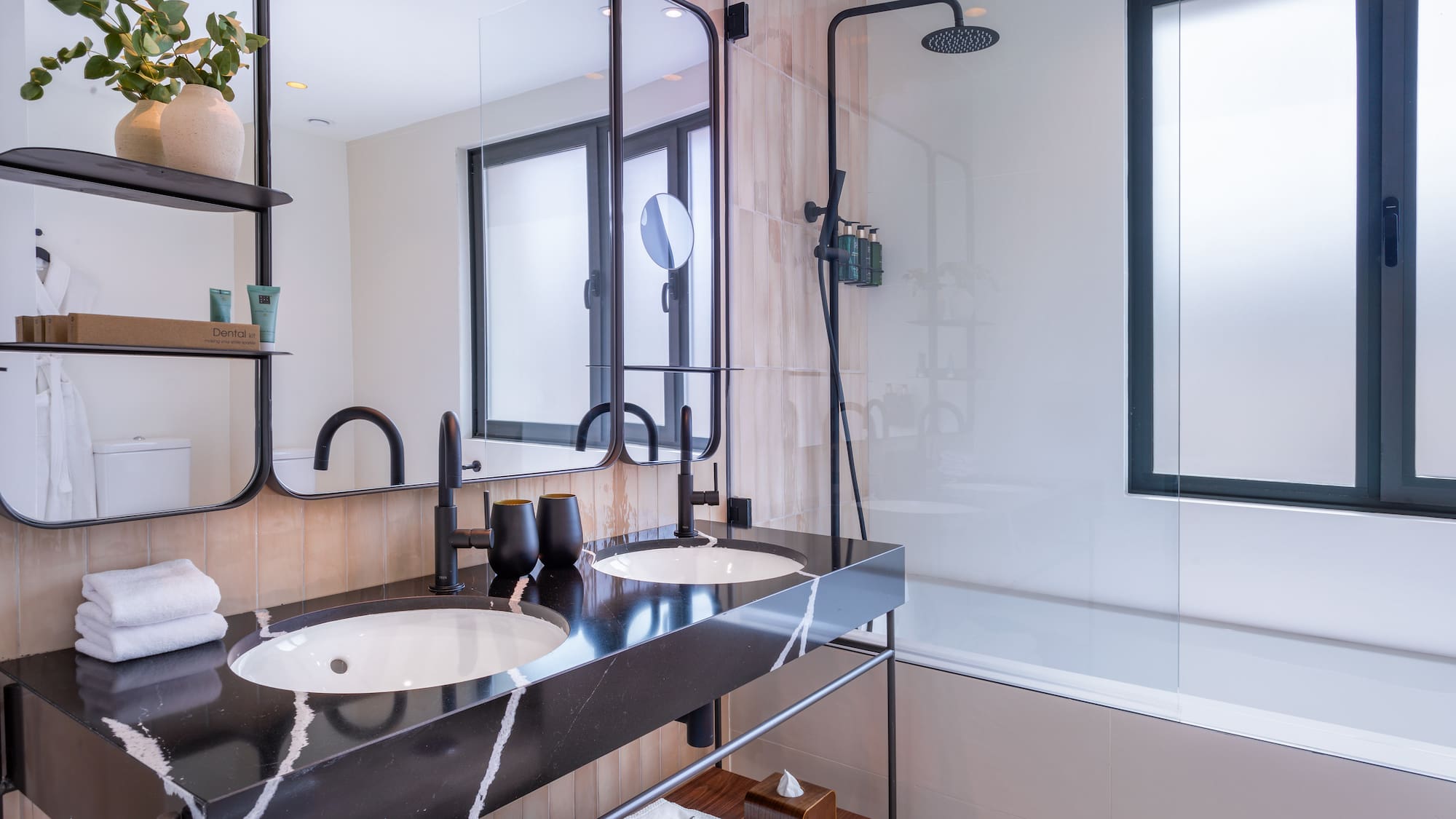 a bathroom with a shower and two sinks