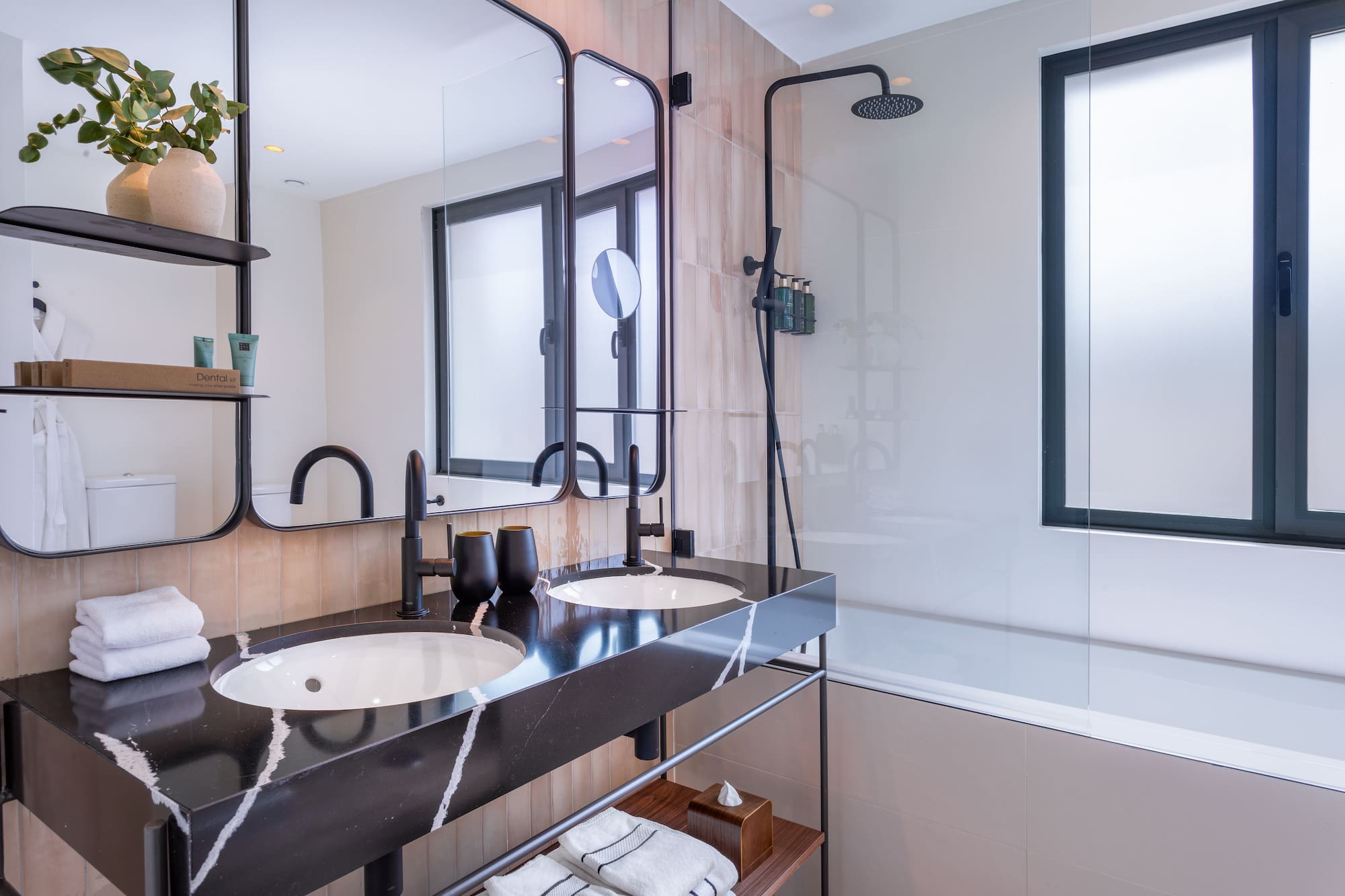 a bathroom with a shower and two sinks