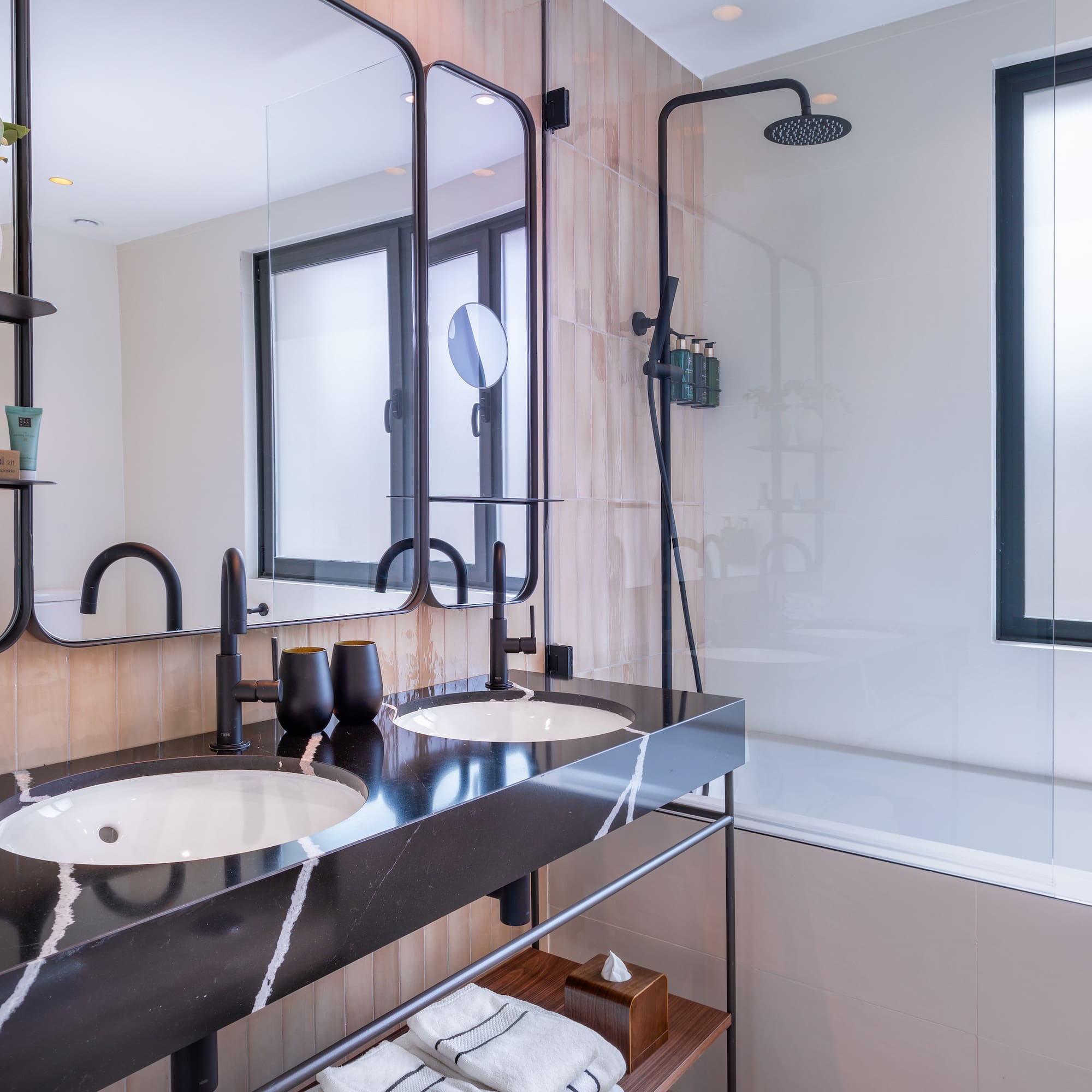 a bathroom with a shower and two sinks