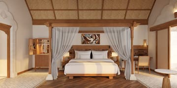 a bed with white curtains and a rug