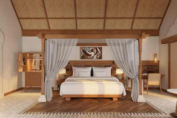 a bed with white curtains and a rug