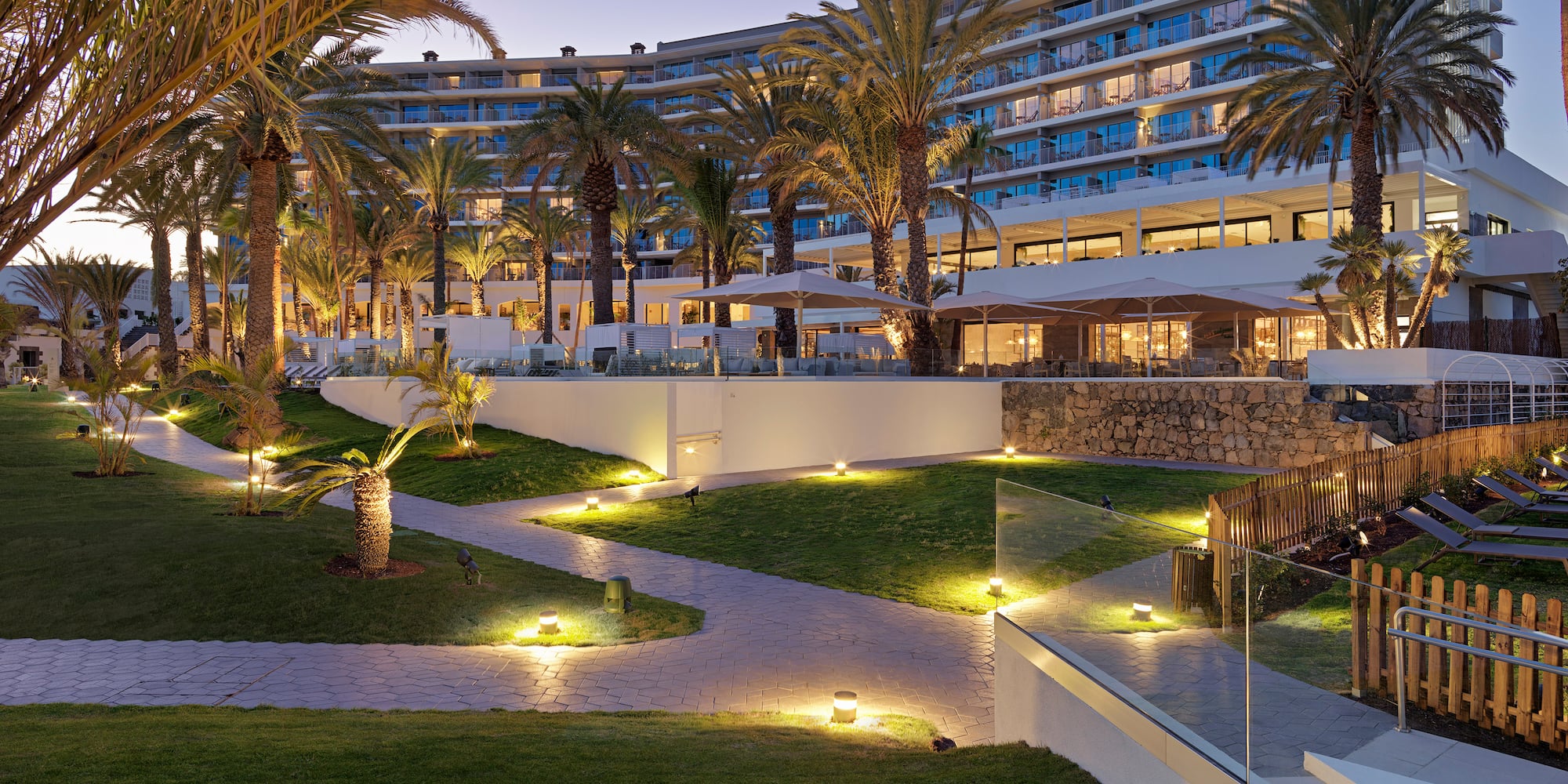 a large hotel with palm trees