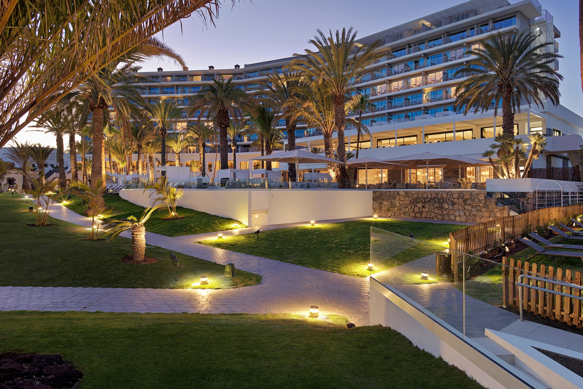 a large hotel with palm trees