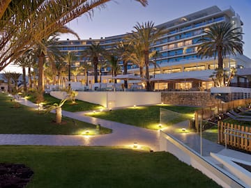 a large hotel with palm trees