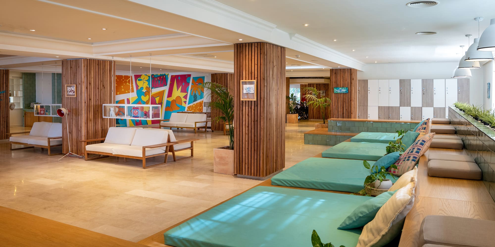 a room with couches and a wall of cabinets