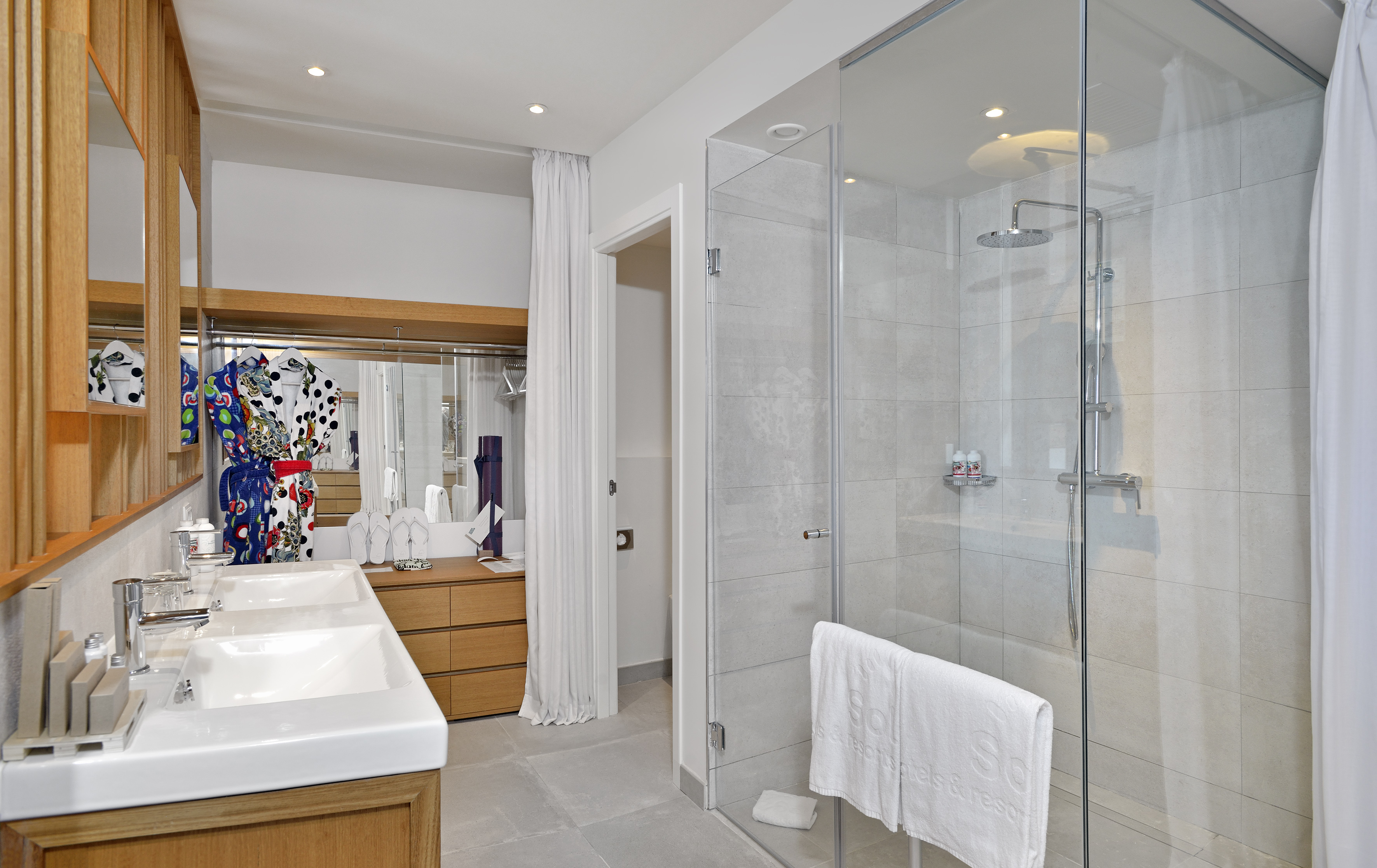 a bathroom with a glass shower and sink