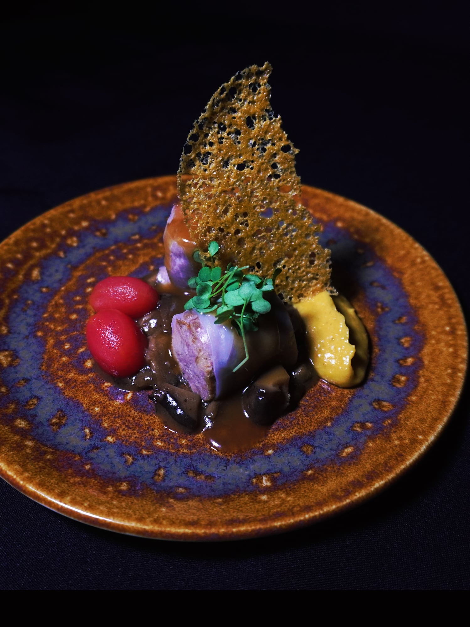 a plate of food on a black surface