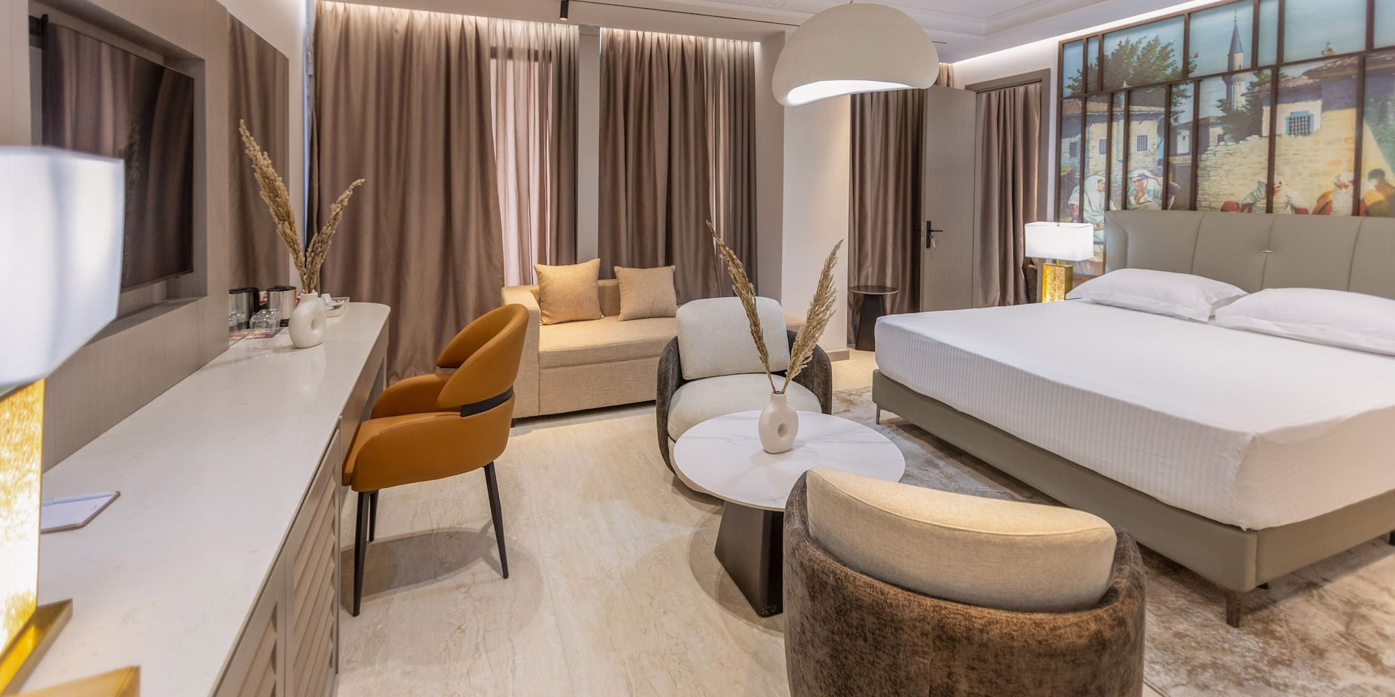 a room with a bed and chairs