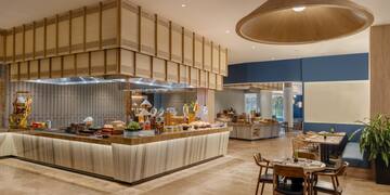 a restaurant with a buffet and a large chandelier