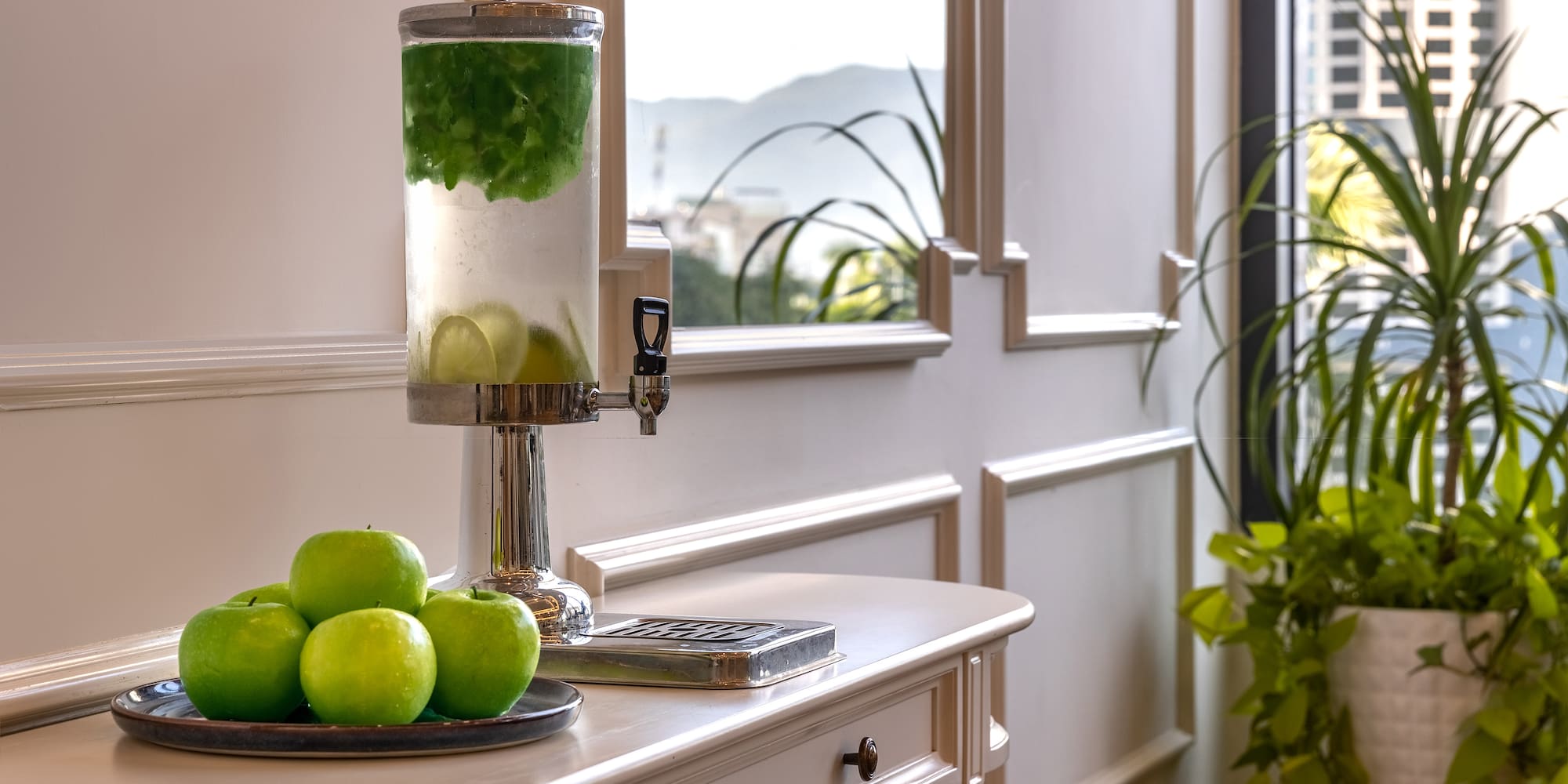a fruit on a plate next to a water dispenser