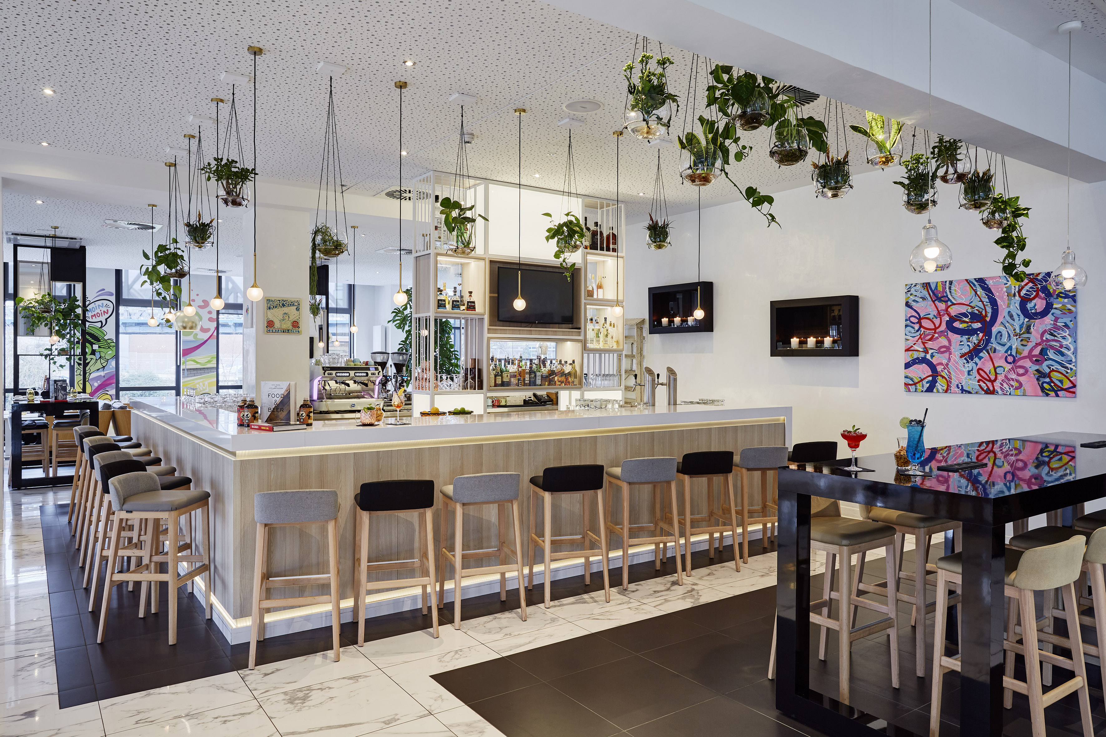 a bar with plants from the ceiling