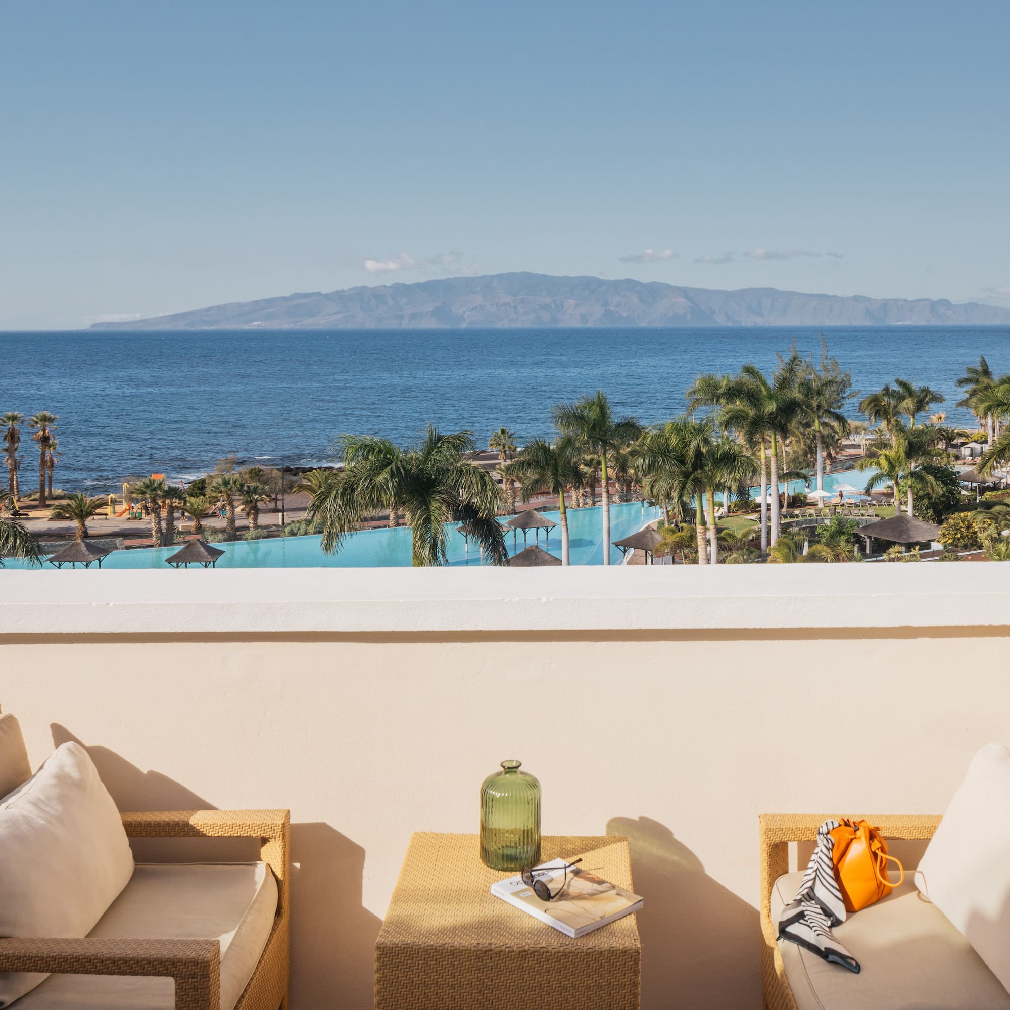 a balcony with a view of the ocean and a beach