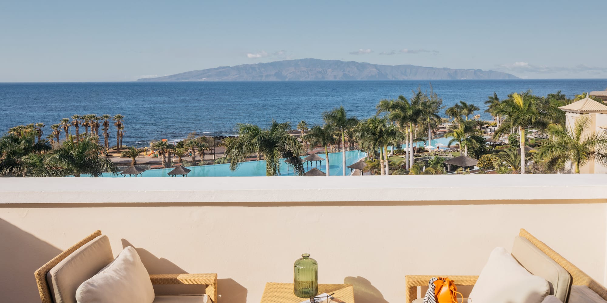 a balcony with a view of the ocean and a beach