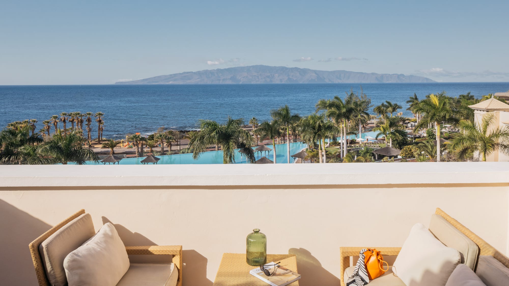 a balcony with a view of the ocean and a beach