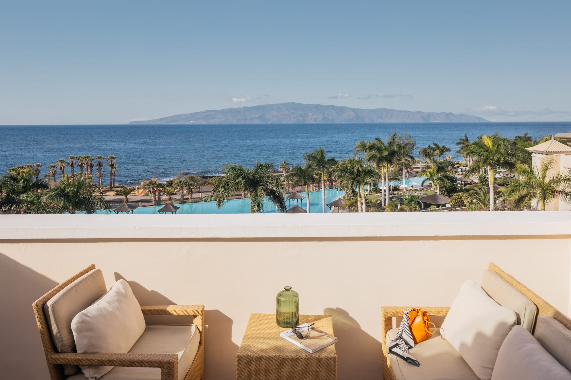 a balcony with a view of the ocean and a beach