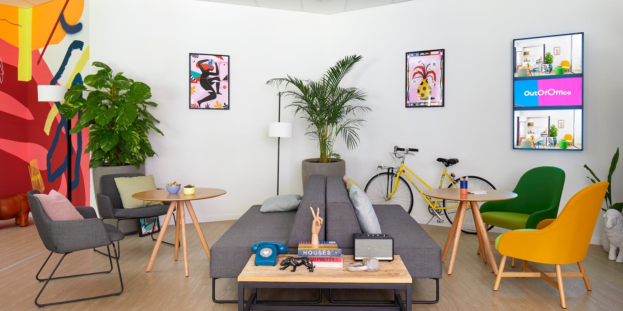 a room with a couch and tables and chairs