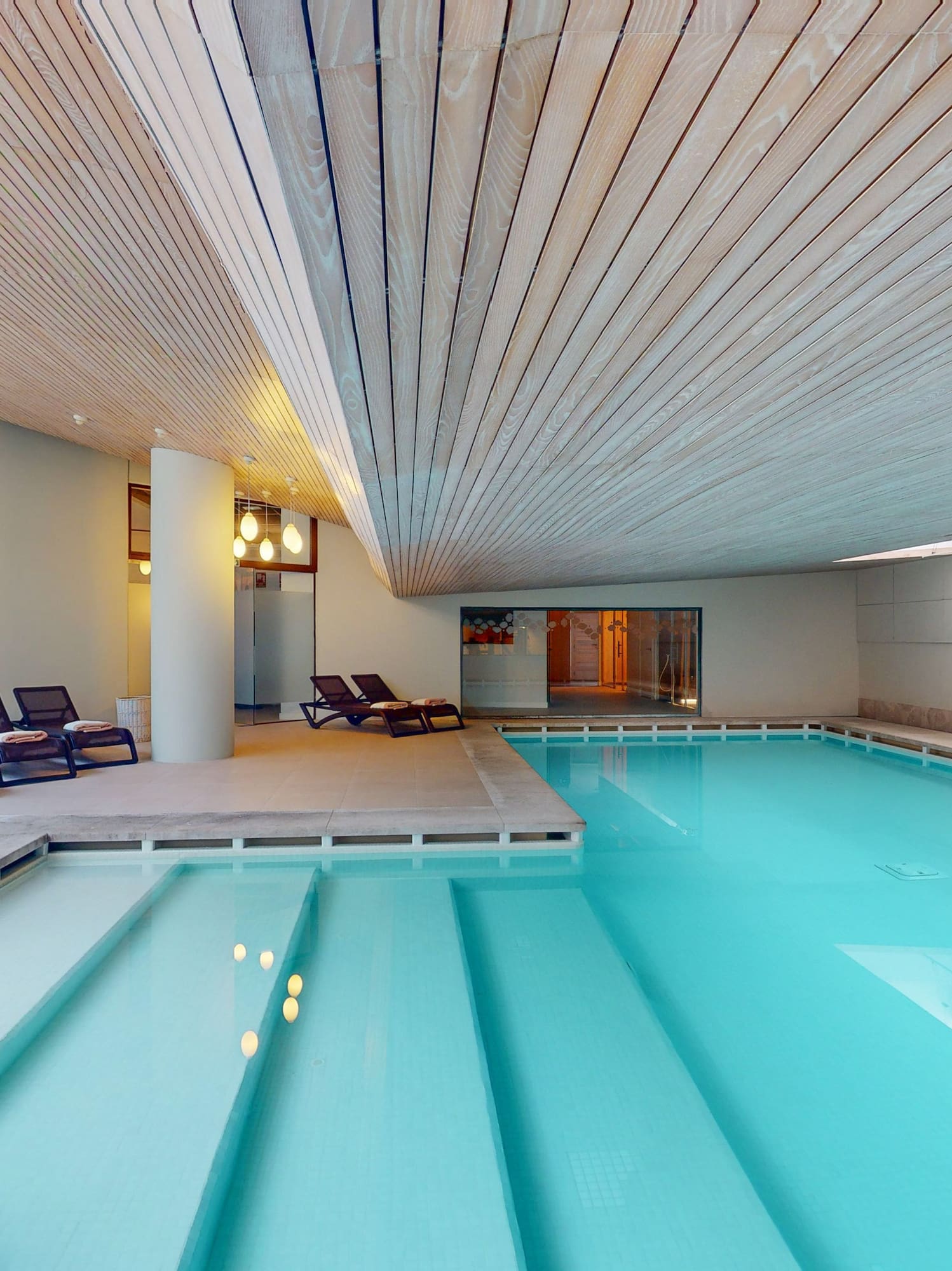 a pool with chairs around it