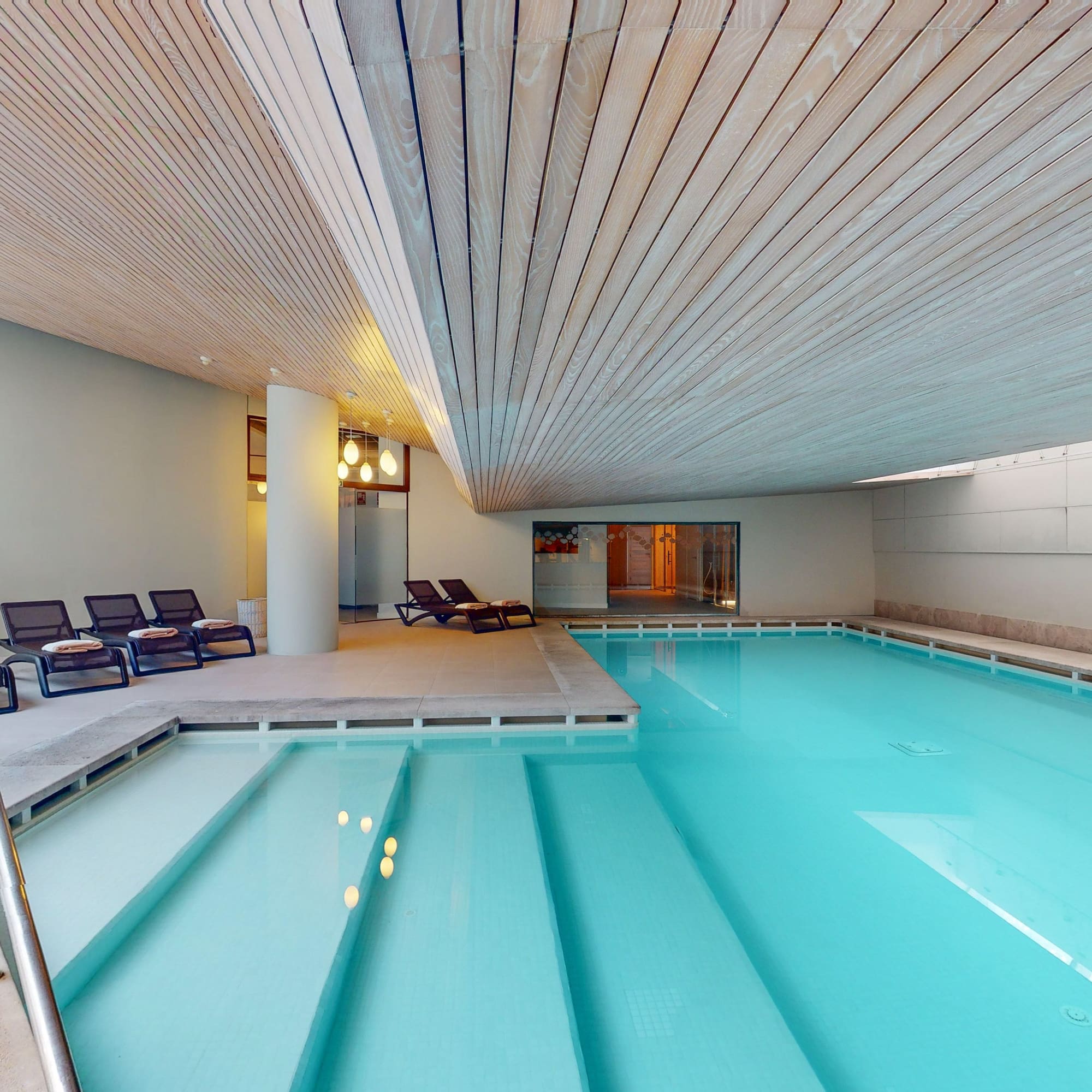 a pool with chairs around it