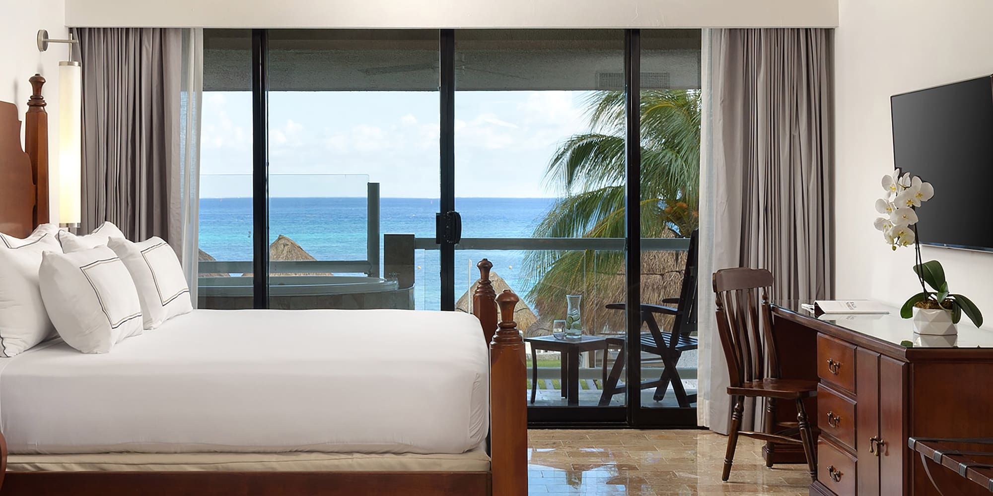 a bedroom with a large bed and a ceiling fan