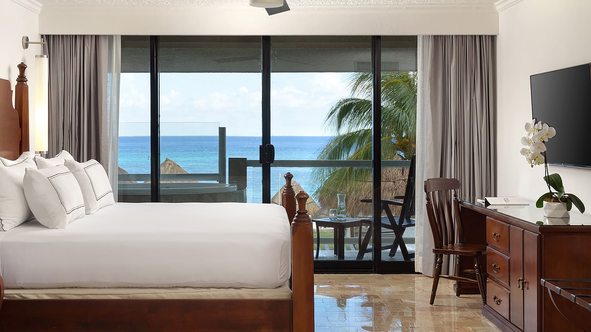 a bedroom with a large bed and a ceiling fan