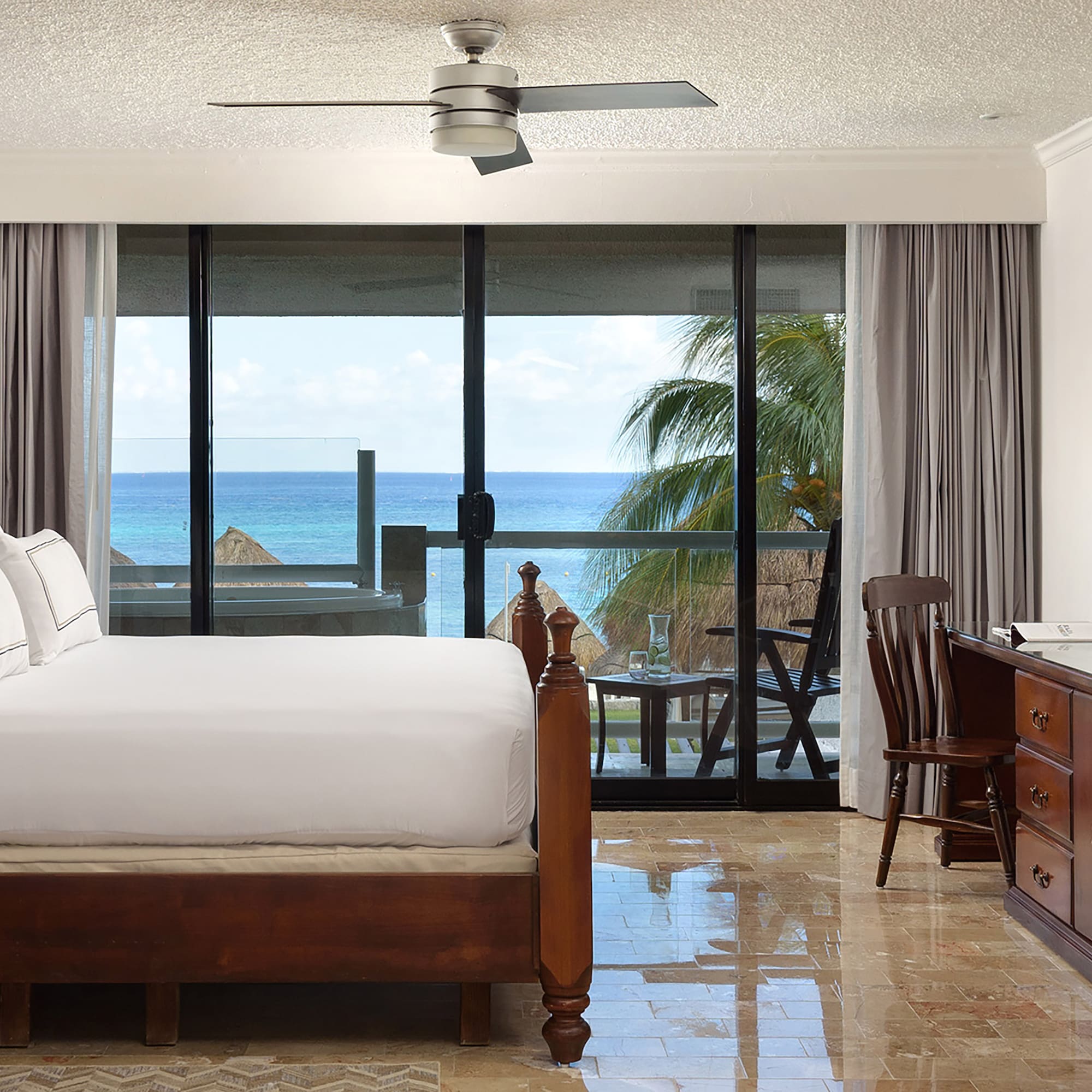 a bedroom with a large bed and a ceiling fan