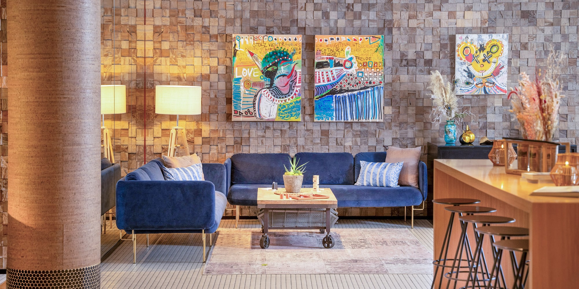 a room with a couch and art on the wall