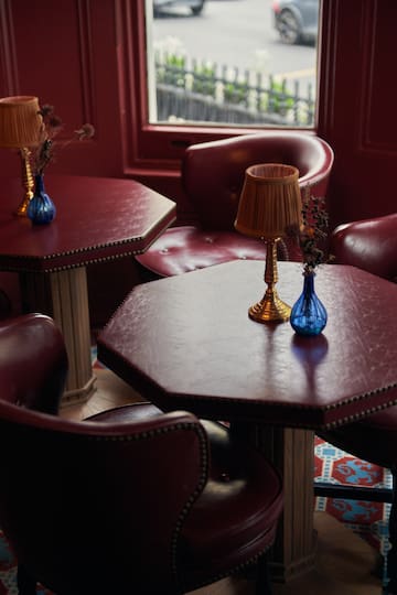 a table with a lamp and vases on it