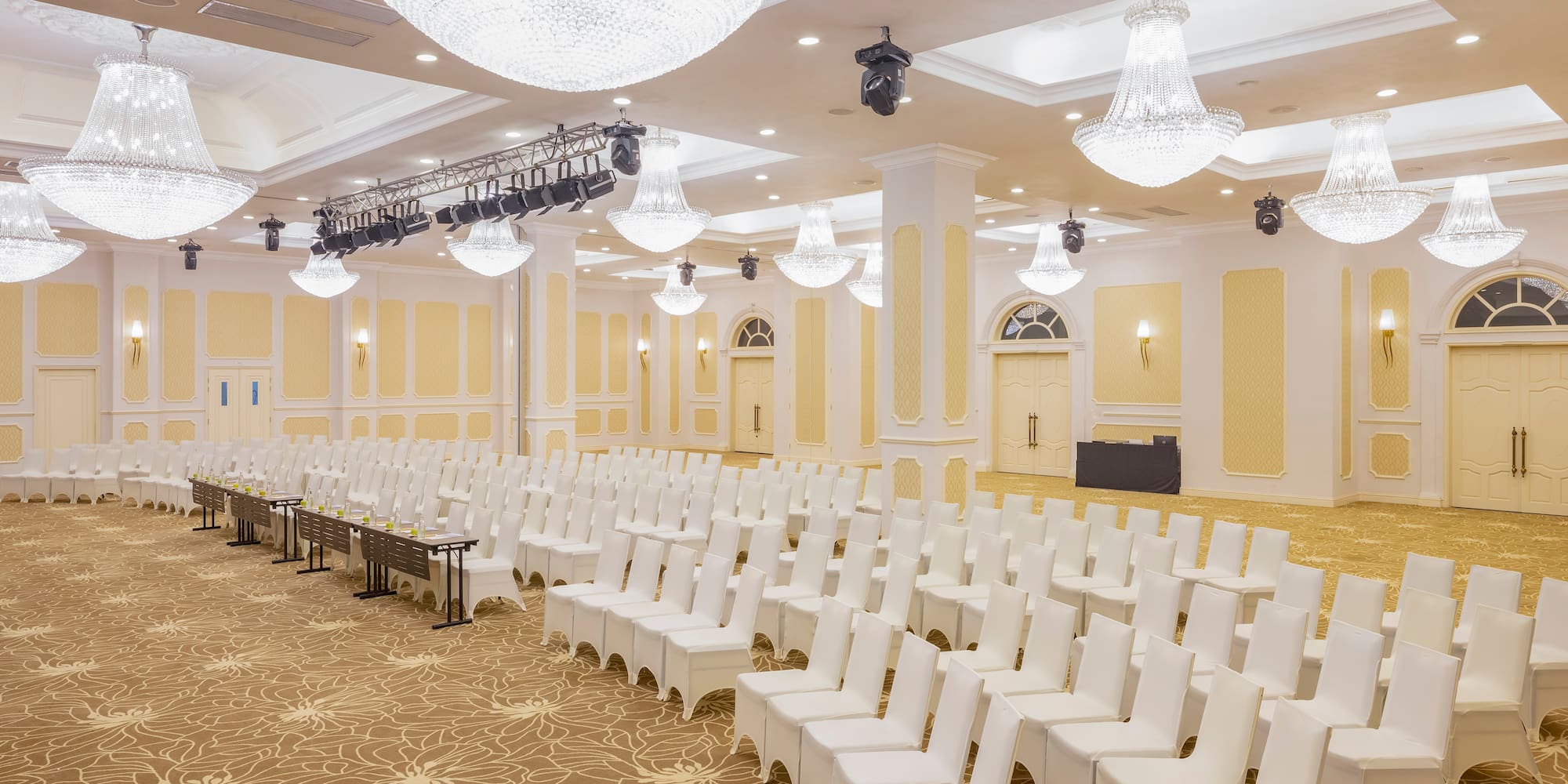 a room with white chairs and lights