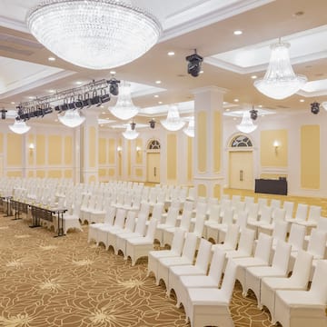 a room with white chairs and lights
