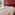 Red hotel bedroom with twin beds, balcony and scenic mountain lake view.