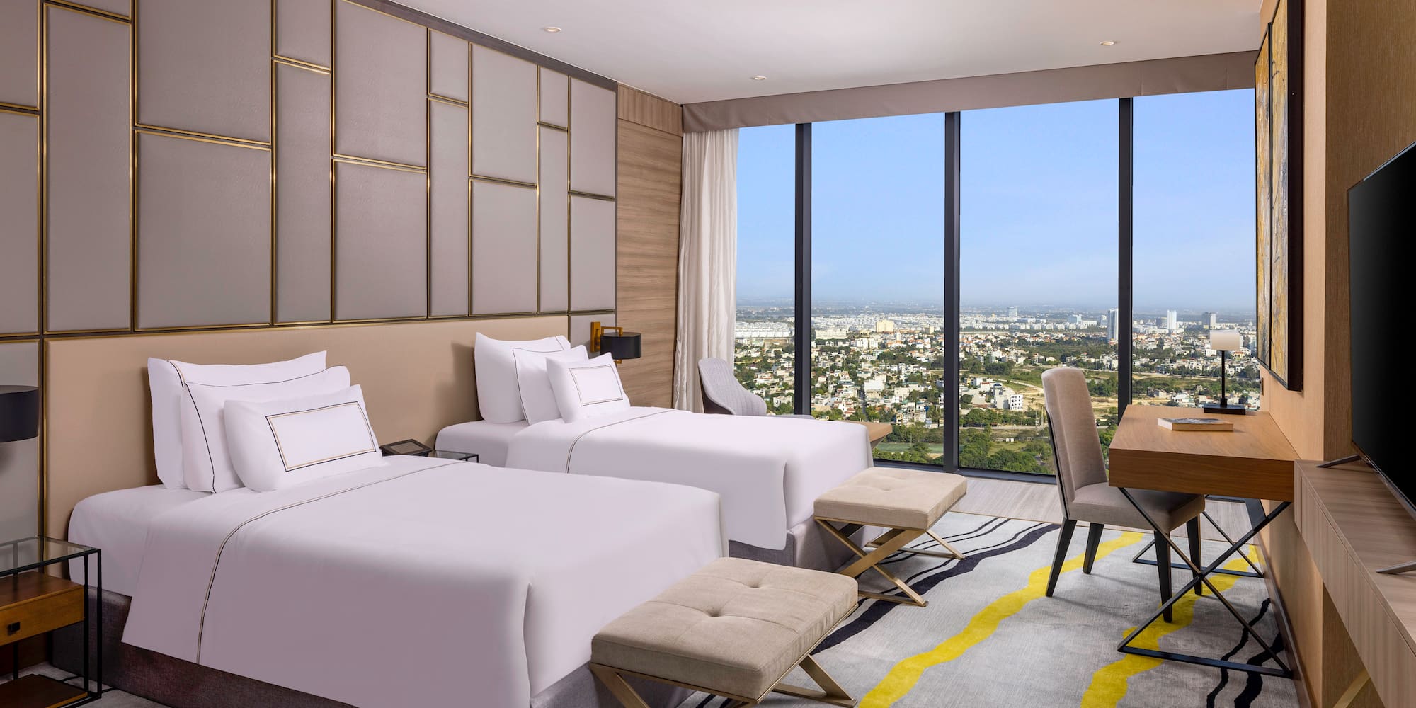 a room with two beds and a table and chairs