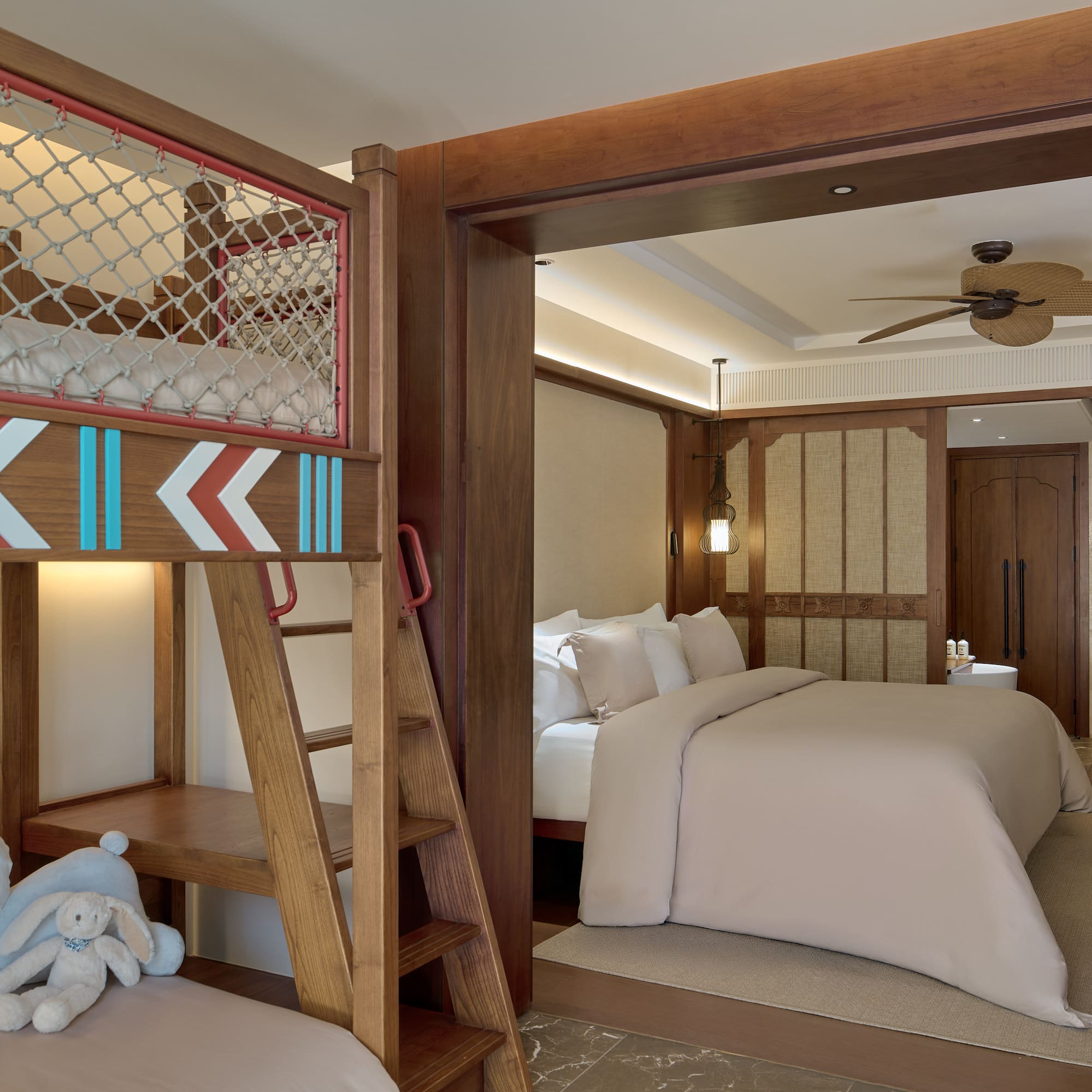 a room with bunk beds and a bed with a ladder