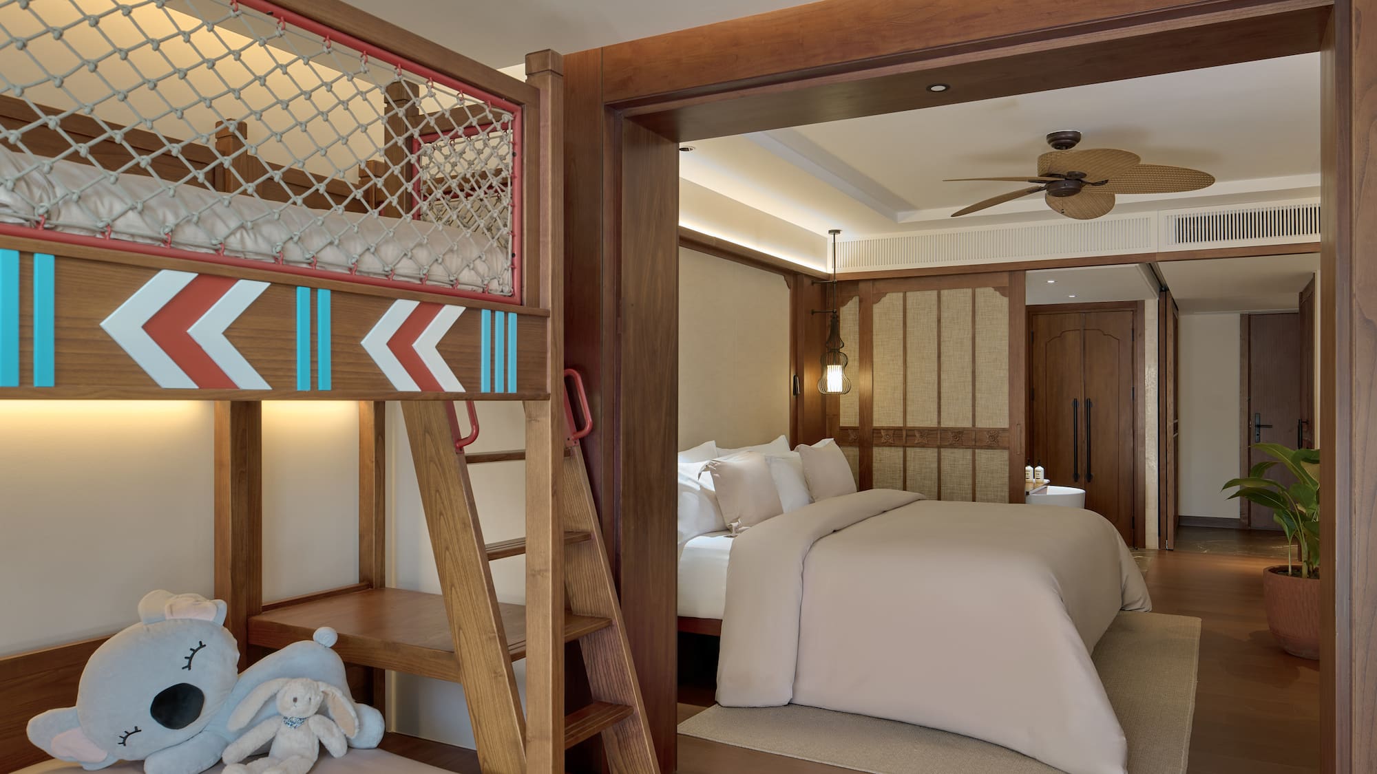 a room with bunk beds and a bed with a ladder