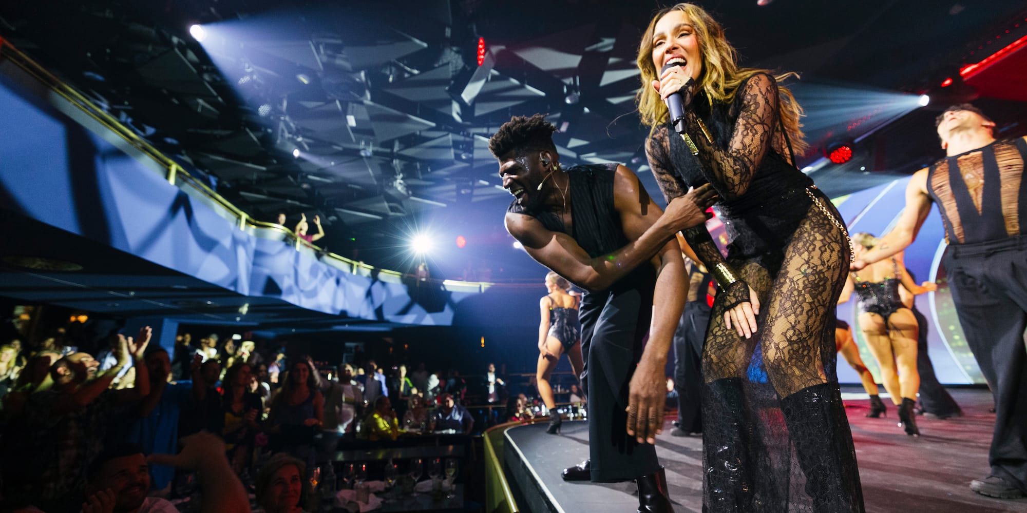 a man and woman on a stage with a microphone