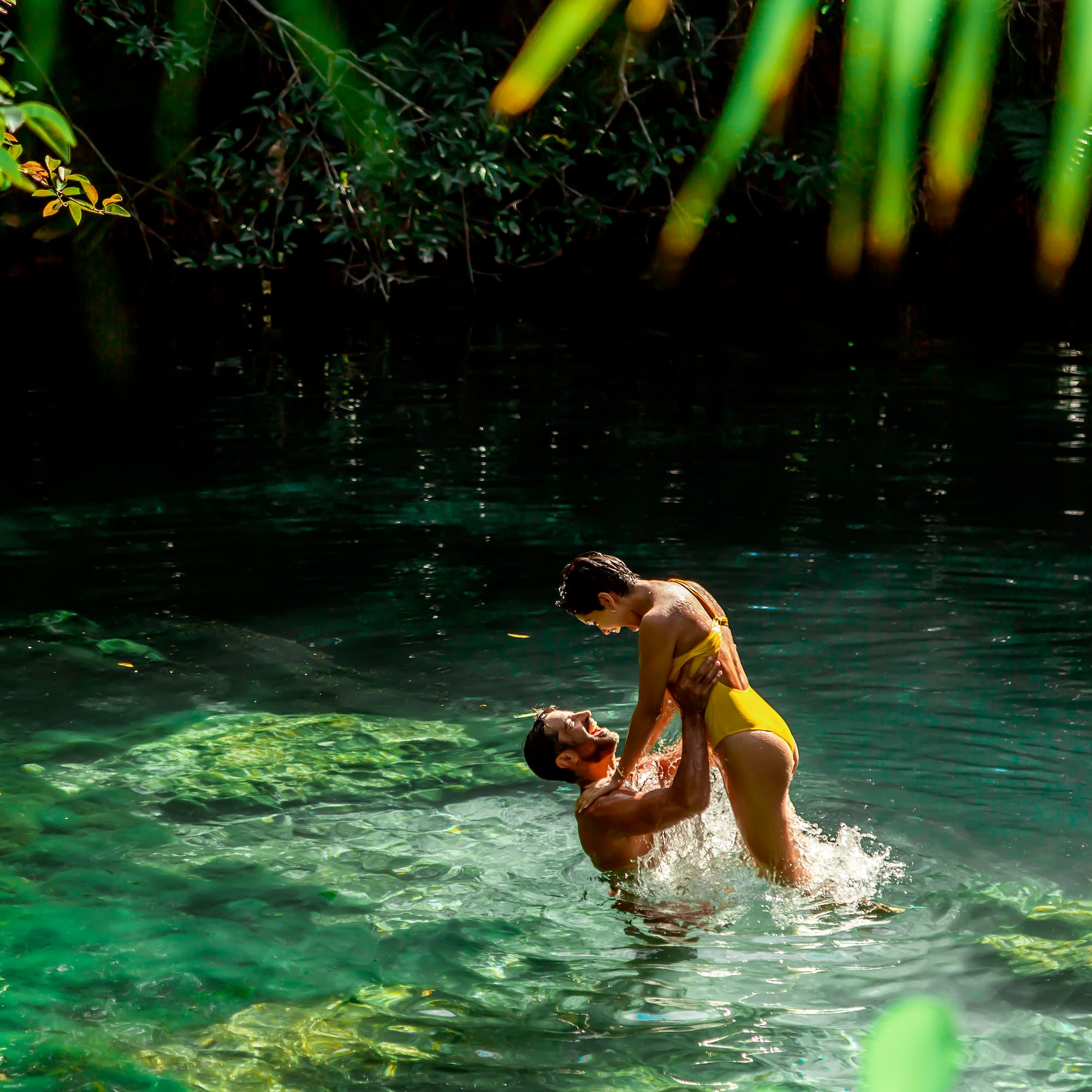 a man and woman in a body of water