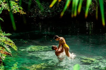 a man and woman in a body of water